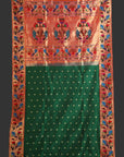Traditional saree with a red and green design on a white background