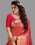 Woman in a red saree with gold patterns on an orange background