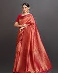 Woman wearing a red saree with a dark background