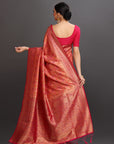 Woman wearing a red saree with a dark background