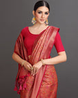 Woman wearing a red saree with a floral pattern on a gray background