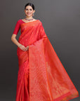 Woman wearing a red saree with a plain background