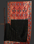 Traditional saree with intricate patterns on a stand