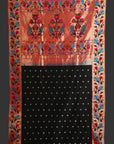 Traditional fabric with intricate patterns and a black square in the center