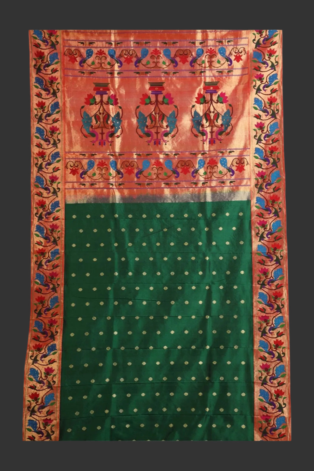 Traditional saree with a red and green design on a white background