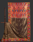 Traditional fabric with intricate patterns on a wooden stand against a white background