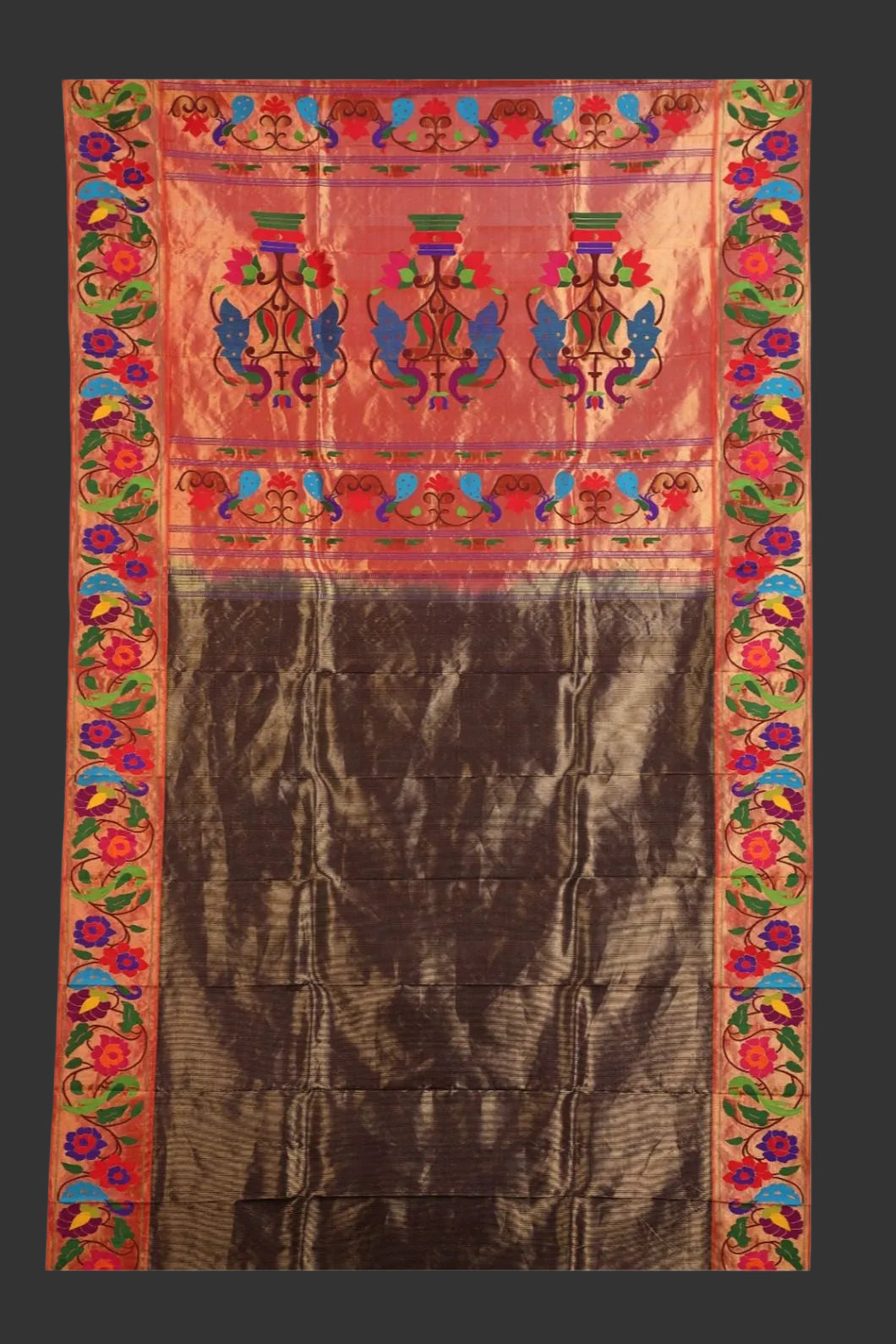 Traditional embroidered fabric with colorful border and central design on a white background