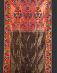 Traditional embroidered fabric with colorful border and central design on a white background