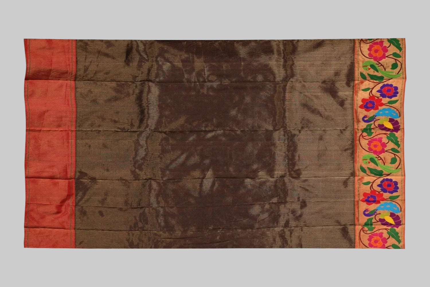 Brown fabric with colorful embroidered border on a white background