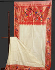 Red and white saree with floral embroidery on a stand