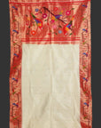 Saree with red border featuring colorful floral and bird patterns on a white background