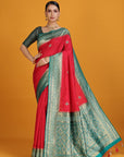 Woman wearing a red and green saree on an orange background