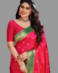 Woman wearing a pink and green saree with a gold blouse on an grey background

