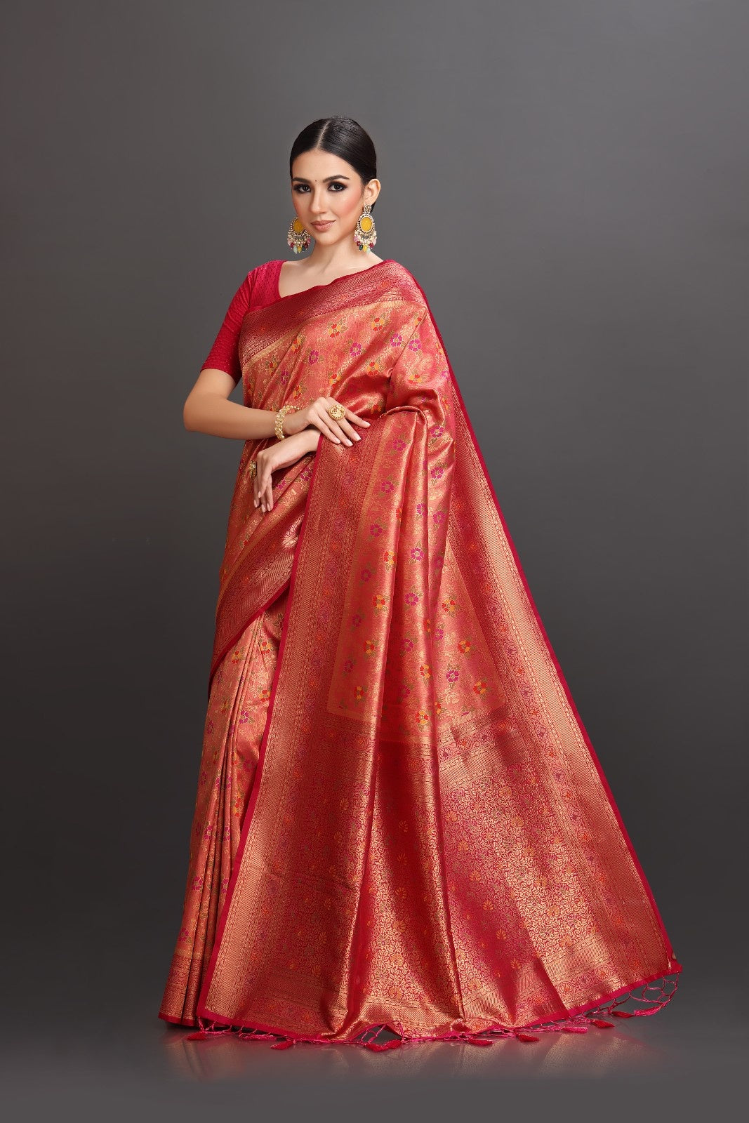 Woman wearing a red saree with a dark background