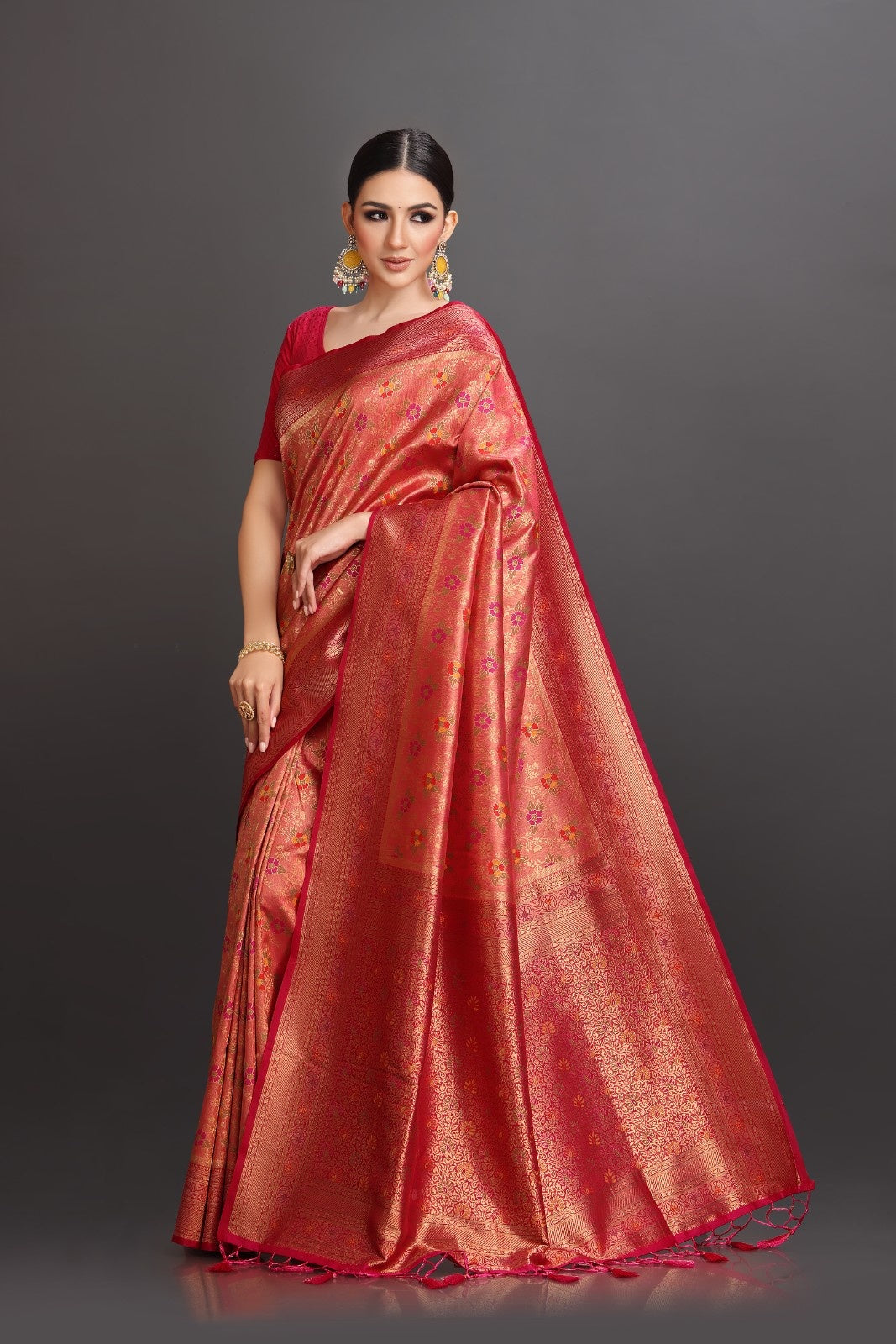 Woman wearing a red saree with a dark background