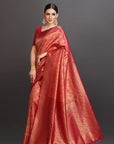 Woman wearing a red saree with a dark background