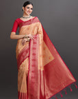 Woman wearing a traditional saree with red and beige colors on a gray background