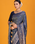 Woman wearing a blue saree with gold patterns on an orange background
