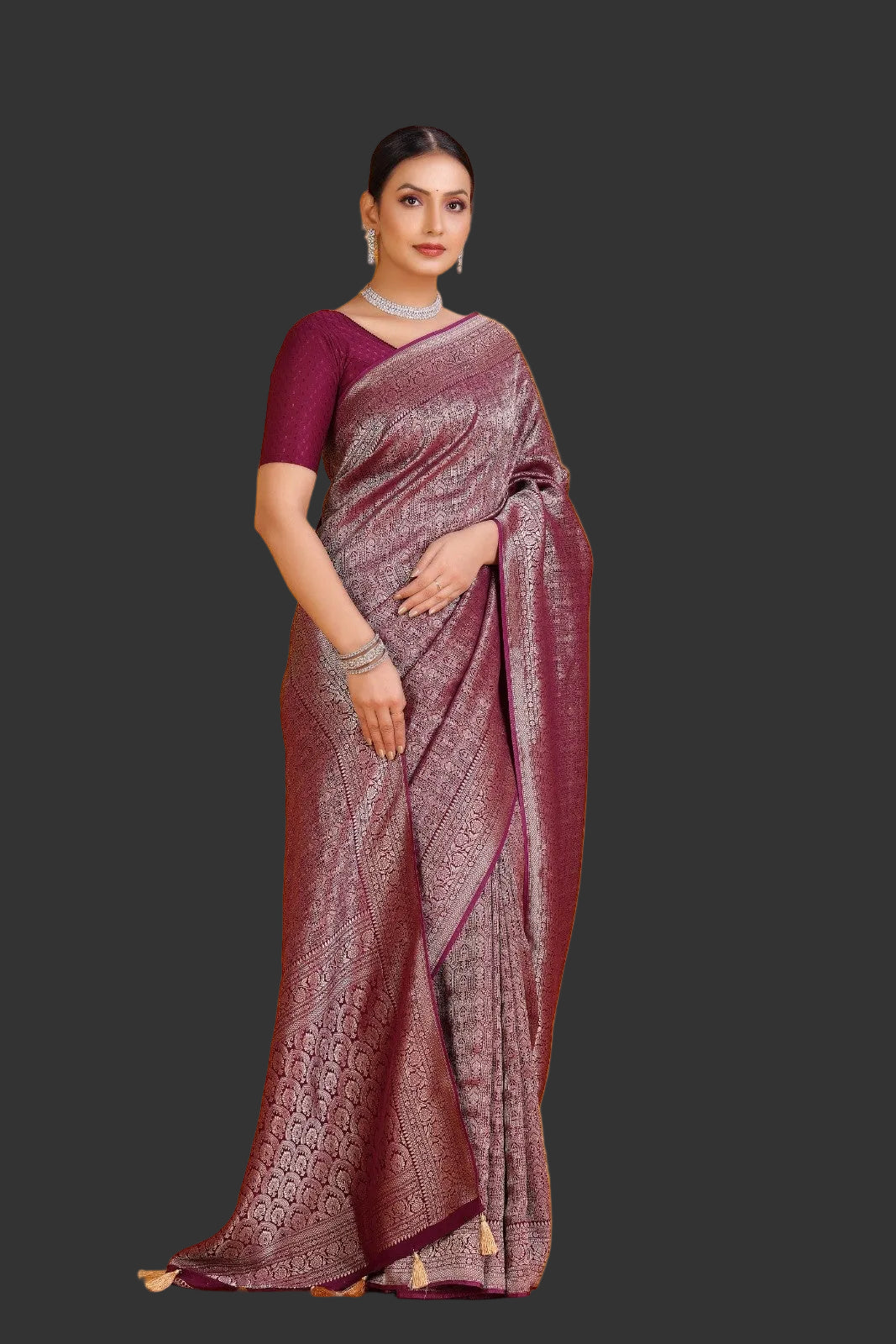 Woman wearing a maroon saree with a pattern on an orange background
