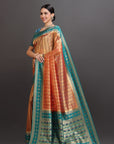 Woman wearing a traditional saree with a gradient of colors on a gray background