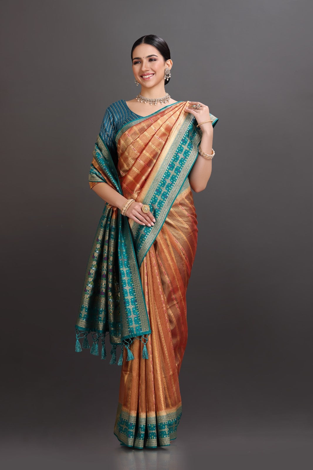 Woman wearing a traditional saree with a dark background