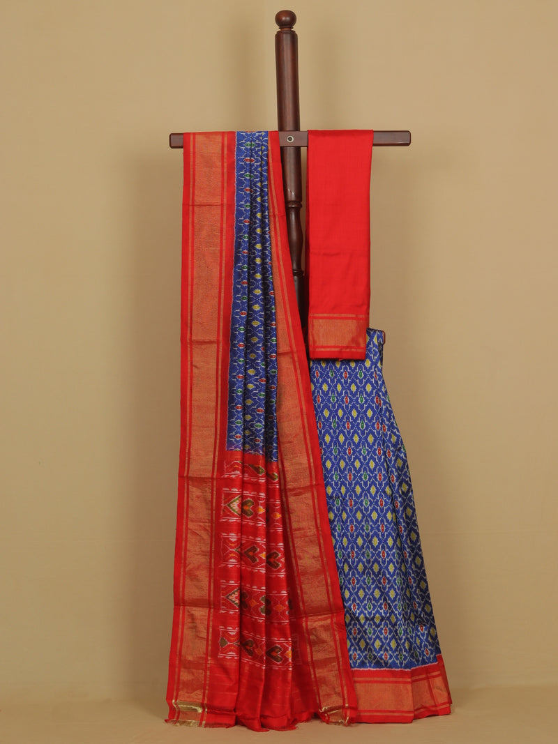 Red and blue saree with a wooden hanger on a beige background